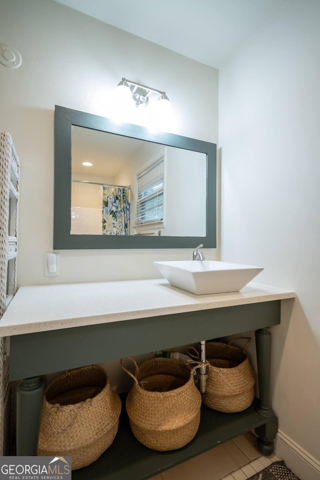 bathroom featuring a shower with curtain, tile patterned flooring, and sink