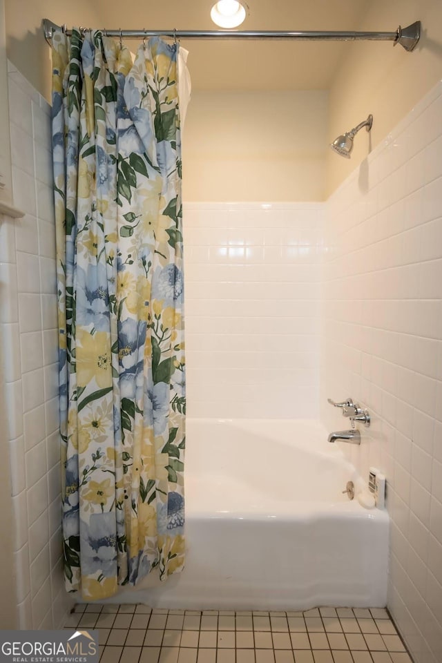 bathroom featuring shower / bathtub combination with curtain and tile patterned flooring