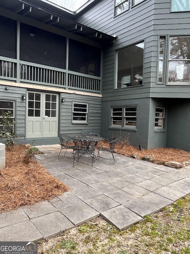 rear view of house with french doors and a patio area