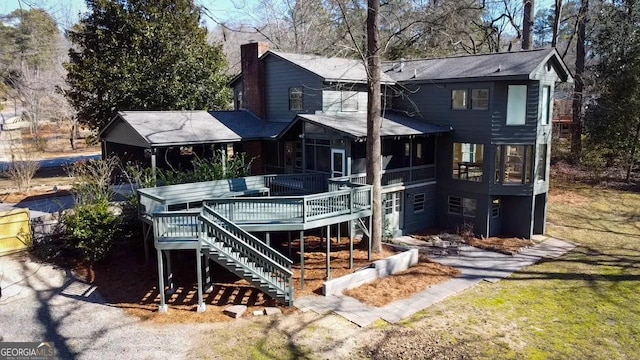 rear view of property featuring a wooden deck