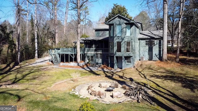 back of house featuring a deck and a lawn