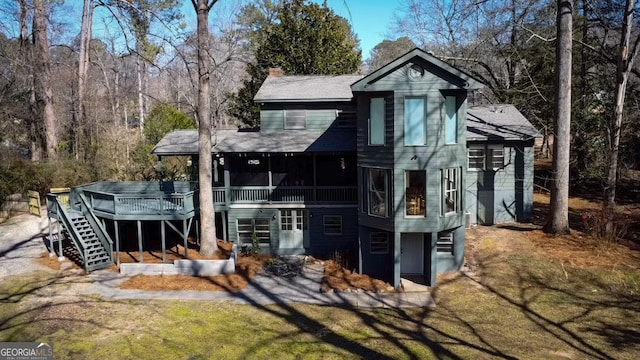 back of house with a wooden deck and a yard