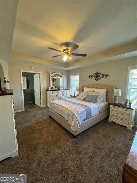 bedroom featuring dark carpet and ceiling fan