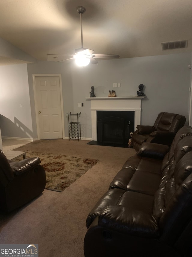 carpeted living room with ceiling fan