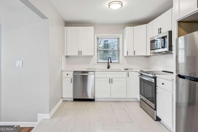 kitchen featuring sink, white cabinets, and appliances with stainless steel finishes