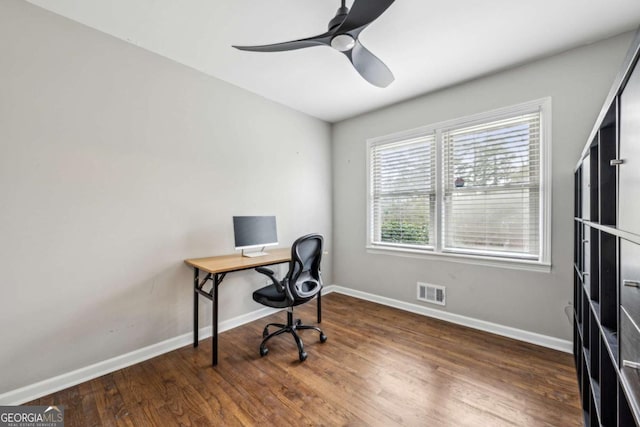 home office featuring dark wood-type flooring and ceiling fan