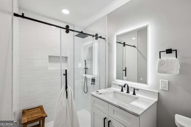 bathroom featuring vanity, toilet, and a shower with door