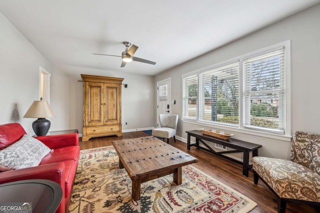 living room with ceiling fan and dark hardwood / wood-style floors