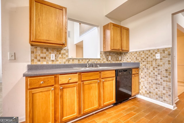 kitchen with black dishwasher, sink, backsplash, and light hardwood / wood-style floors