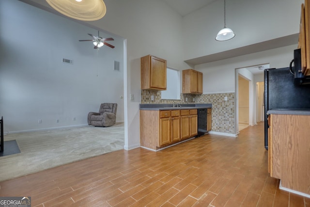 kitchen with ceiling fan, hanging light fixtures, high vaulted ceiling, black appliances, and decorative backsplash