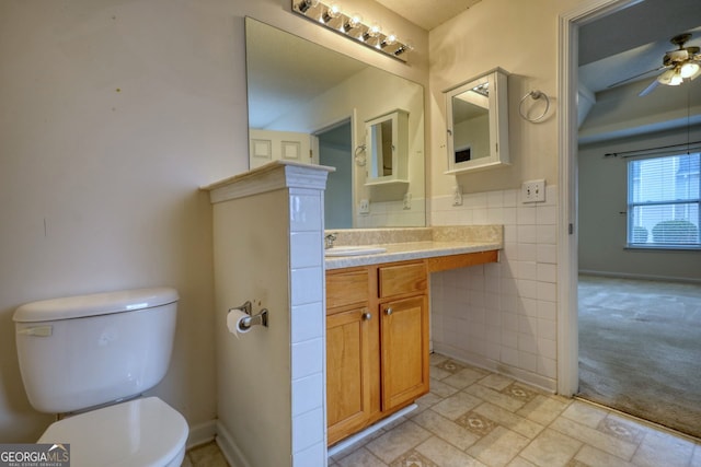 bathroom featuring ceiling fan, vanity, and toilet