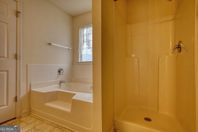 bathroom featuring separate shower and tub