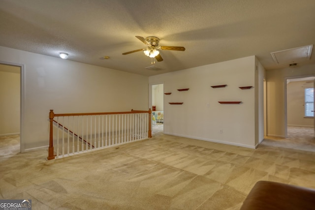 carpeted spare room with a textured ceiling