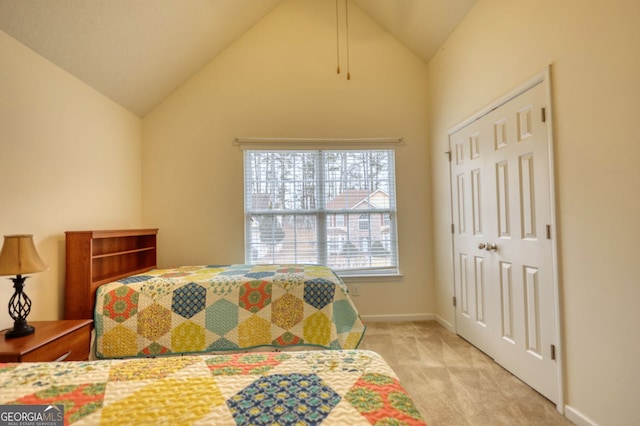 carpeted bedroom featuring lofted ceiling