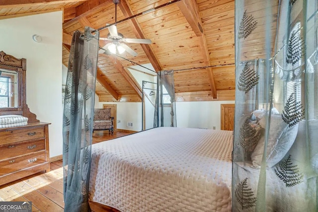 bedroom with wood ceiling, ceiling fan, light hardwood / wood-style floors, and vaulted ceiling with beams