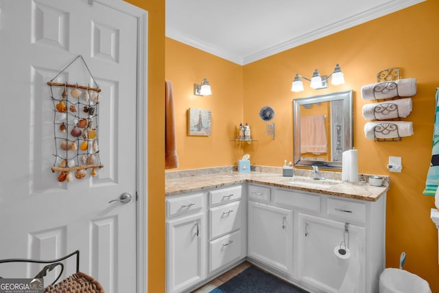 bathroom featuring crown molding and vanity