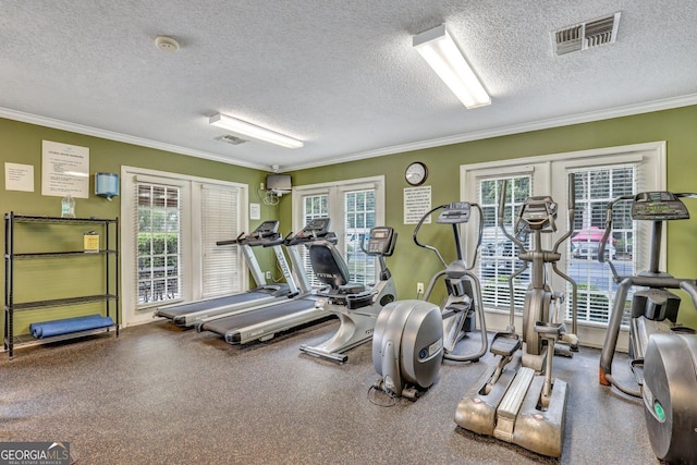 gym with ornamental molding, a textured ceiling, and french doors