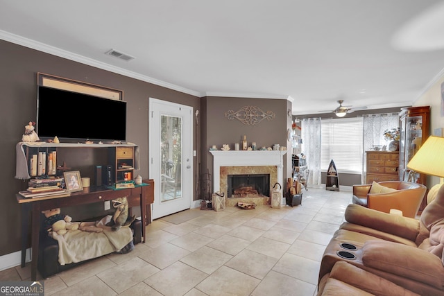 living room with ceiling fan, ornamental molding, and light tile patterned floors