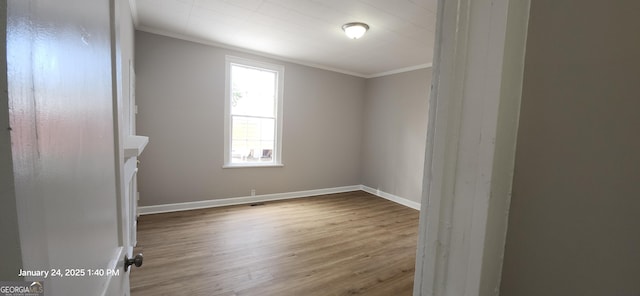 unfurnished room featuring hardwood / wood-style floors and ornamental molding