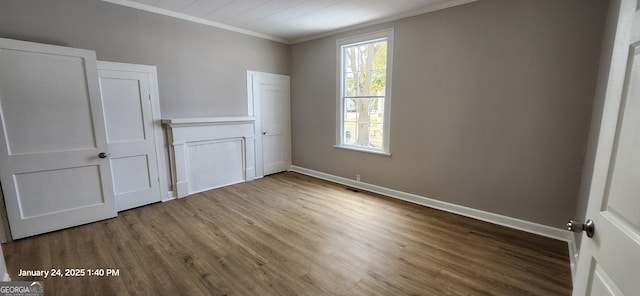 unfurnished bedroom featuring ornamental molding and hardwood / wood-style floors