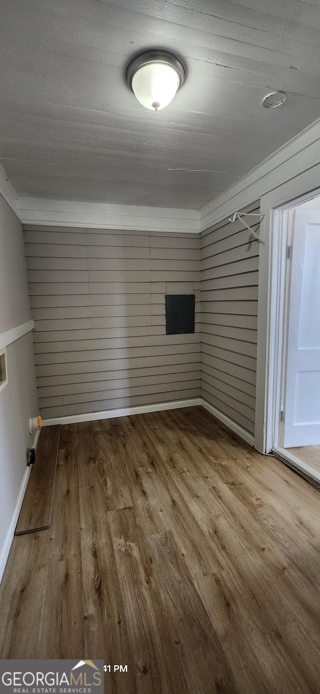 spare room with hardwood / wood-style floors and ornamental molding