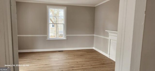 unfurnished room with crown molding and wood-type flooring