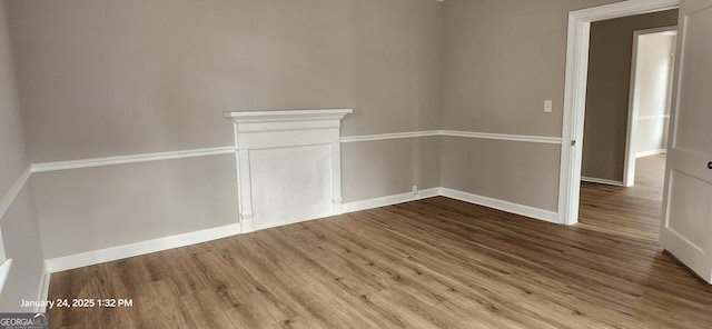 unfurnished room with hardwood / wood-style flooring