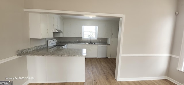 kitchen featuring sink, white appliances, light hardwood / wood-style flooring, white cabinetry, and kitchen peninsula