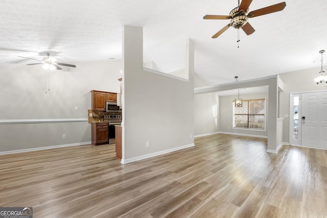 unfurnished living room featuring light wood finished floors, baseboards, high vaulted ceiling, and ceiling fan with notable chandelier