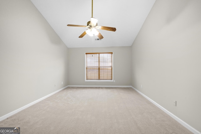 empty room featuring visible vents, light carpet, vaulted ceiling, ceiling fan, and baseboards