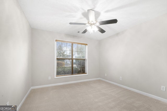 unfurnished room with light carpet, ceiling fan, and baseboards