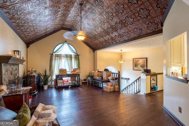 interior space featuring lofted ceiling, an ornate ceiling, a healthy amount of sunlight, and dark wood finished floors