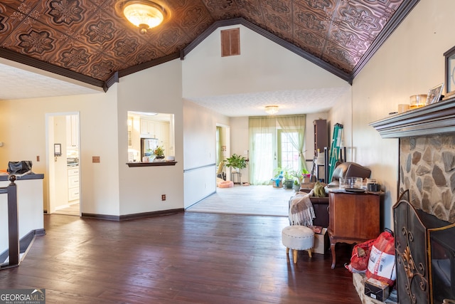 foyer entrance featuring an ornate ceiling, baseboards, ornamental molding, dark wood-style flooring, and high vaulted ceiling