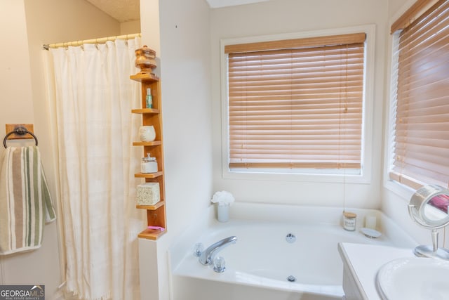 bathroom with vanity, curtained shower, and a garden tub