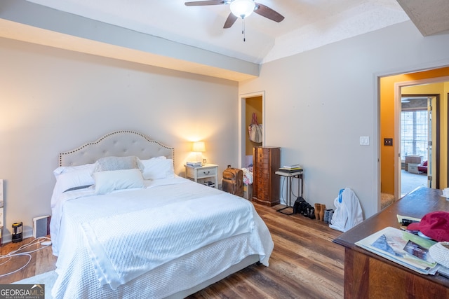 bedroom with vaulted ceiling, visible vents, ceiling fan, and wood finished floors