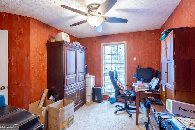 office featuring ceiling fan, light carpet, and a textured ceiling