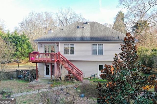 rear view of property with fence, french doors, a deck, a patio, and stairs