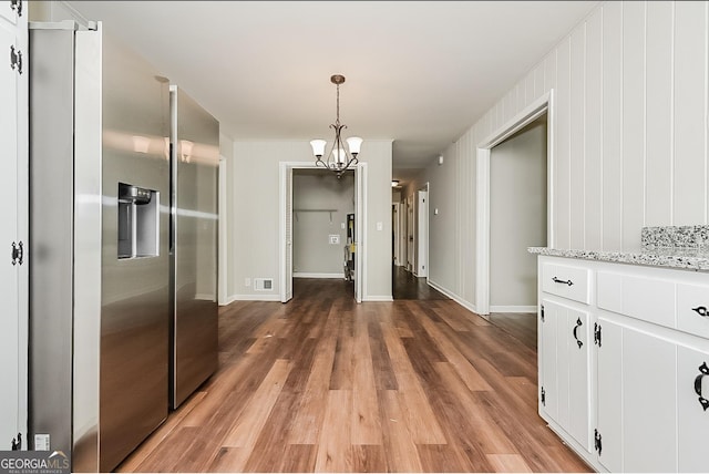 unfurnished dining area featuring dark hardwood / wood-style flooring and a chandelier