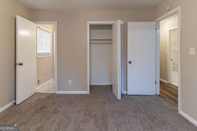 unfurnished bedroom featuring carpet floors and a closet