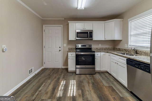 kitchen featuring stone counters, appliances with stainless steel finishes, white cabinets, and dark hardwood / wood-style flooring