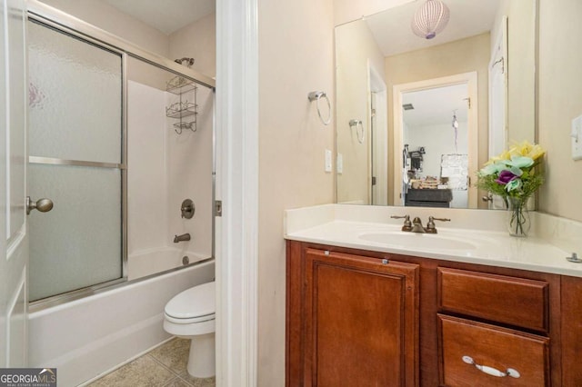 full bathroom featuring ensuite bathroom, tile patterned flooring, toilet, vanity, and combined bath / shower with glass door