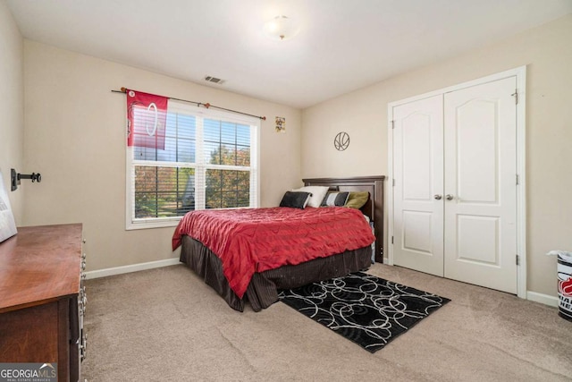 carpeted bedroom with visible vents and baseboards