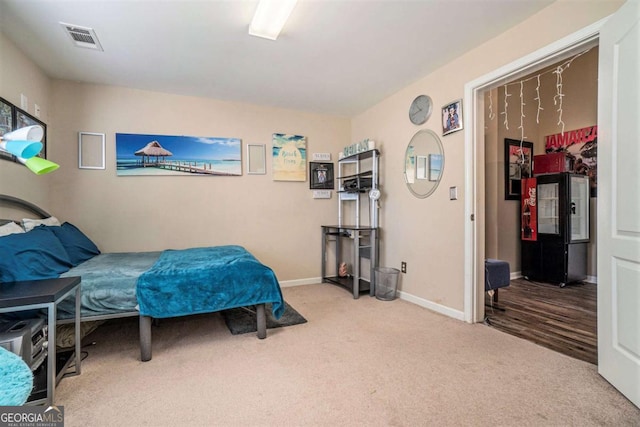 carpeted bedroom with visible vents and baseboards