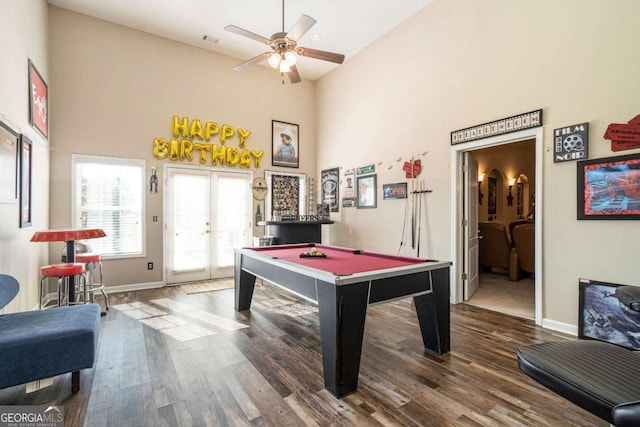 playroom with a high ceiling, billiards, wood finished floors, baseboards, and french doors