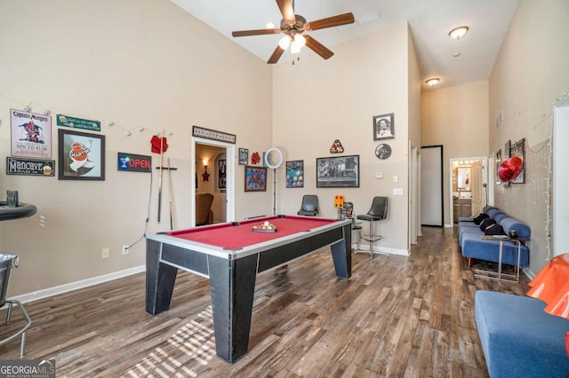 playroom featuring baseboards, billiards, a high ceiling, and wood finished floors