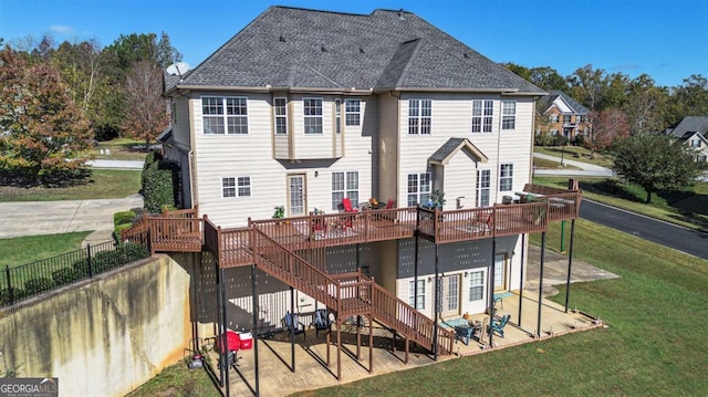 back of property with a lawn, stairway, fence, a deck, and a patio area