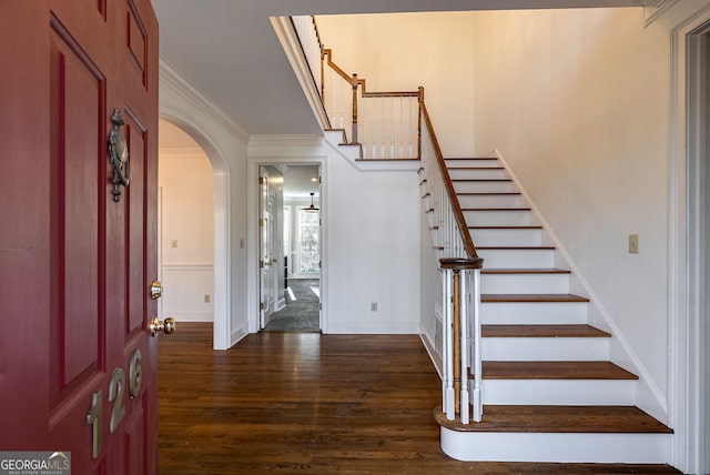 entrance foyer featuring ornamental molding and dark hardwood / wood-style floors