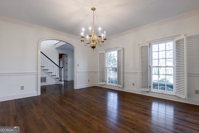 spare room with ornamental molding, plenty of natural light, an inviting chandelier, and dark hardwood / wood-style flooring