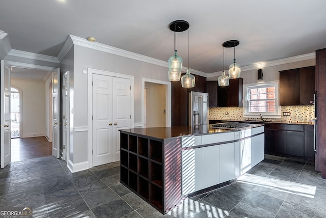 kitchen featuring a kitchen island, tasteful backsplash, sink, dark brown cabinetry, and stainless steel appliances