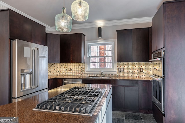 kitchen featuring stainless steel appliances, sink, dark stone countertops, and backsplash